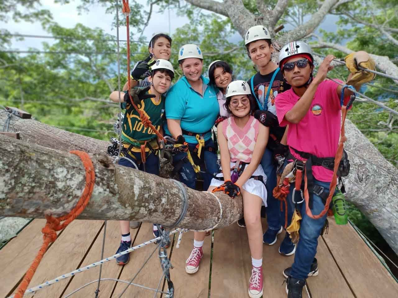 Immersion Trip group posing on a zip line course in Nicaragua.